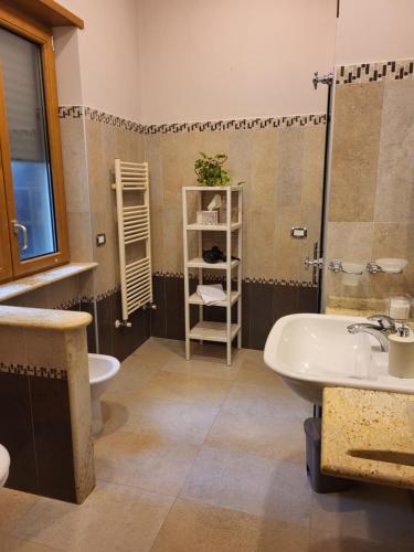 a bathroom with a sink and a toilet and a tub at La torre in Velletri