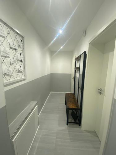 a hallway with a mirror and a wooden table at Ferienwohnung H&M Immobilien - Geiseltalsee in Braunsbedra