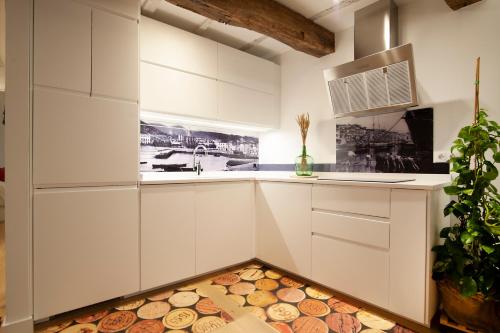 a kitchen with white cabinets and a sink at Aittitta Makurra etxea in Lekeitio