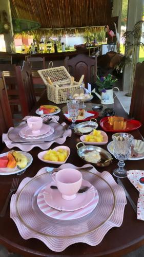 a table with plates and bowls of food on it at Pousada Marajoara- Hotel Fazenda-Turismo de Aventura in Soure