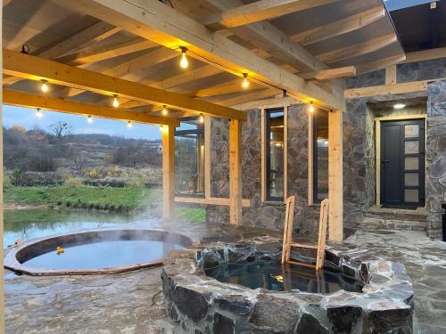 a patio with a hot tub in a stone building at BrickWood in Verkhniy Koropets