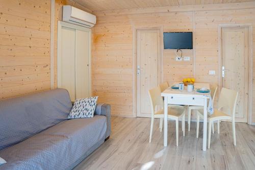 a living room with a couch and a table at Villaggio Smeraldo in Moneglia