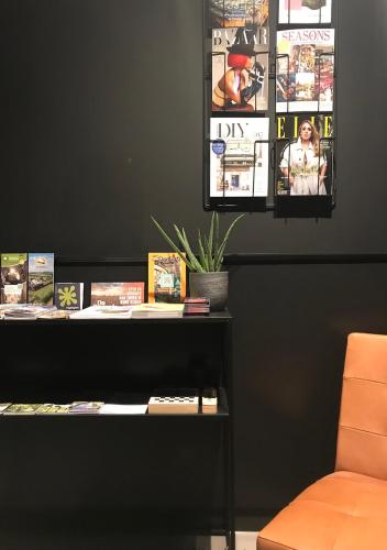 a table with books and a chair in a room at B&B De Oude Dorpsslagerij in Nuth