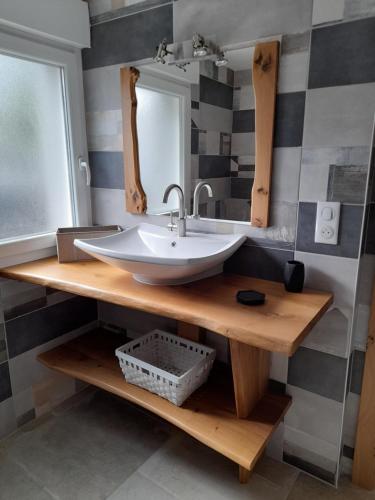 a bathroom with a sink and a mirror at Au fil du bois in Contrexéville