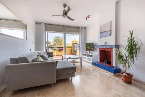 a living room with a couch and a fireplace at Apartamento Dúplex Los Cartujanos I in Marbella