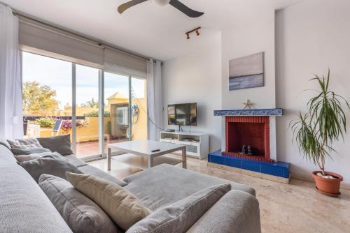 a living room with a couch and a fireplace at Apartamento Dúplex Los Cartujanos I in Marbella