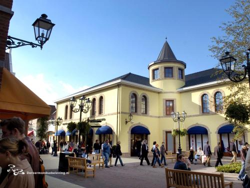 a large building with people walking in front of it at De Roermondse beleving in Roermond