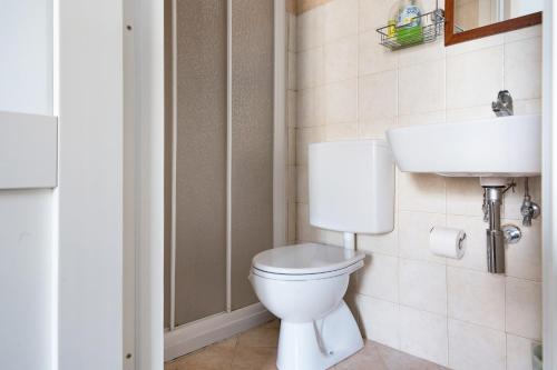 a bathroom with a white toilet and a sink at Domus Julia in Garessio