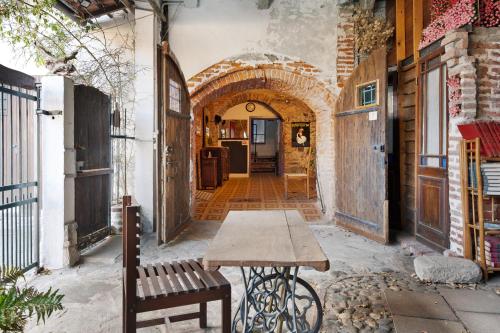 an alleyway with a wooden table and a bench at Domus Julia in Garessio
