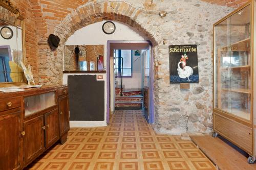 a kitchen with a brick wall and a doorway at Domus Julia in Garessio