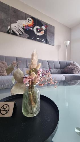 a vase of flowers on a table in a living room at FeWo Resse in Gelsenkirchen