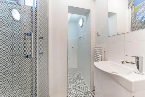 a bathroom with a shower and a sink at Hello Apartments Sw Ducha Loft for 4 guests in Gdańsk