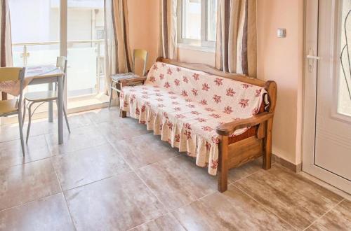 a room with a couch and a table and a window at Despinas Seafront Apartments,Haraki in Haraki