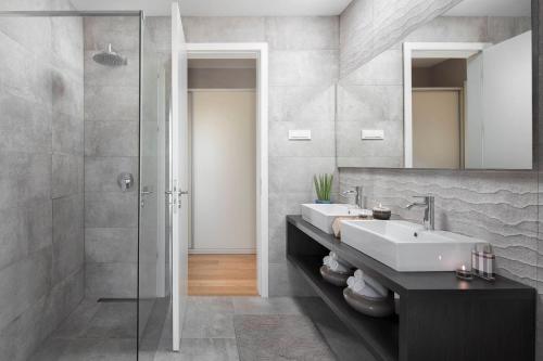 a bathroom with two sinks and a shower at Villa Royale Croatia with Golf Green in Brtonigla in Brtonigla