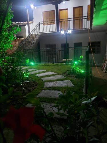 a walkway in front of a house at night at Pouso Casa da Vovó in Tiradentes