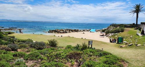a beach with people on the sand and the ocean at Main Sail 4 Port St Francis in St Francis Bay