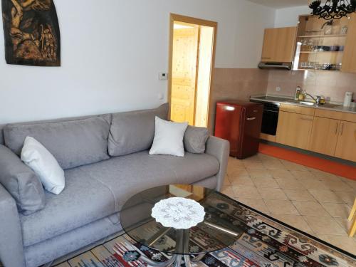 a living room with a couch and a glass table at Apartma Slavc in Kranjska Gora