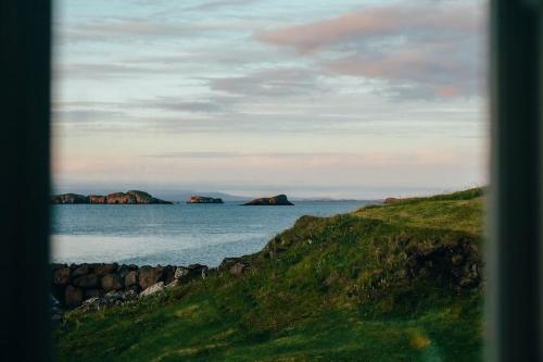a view of the ocean with rocks in the water at Tanginn in Stykkishólmur