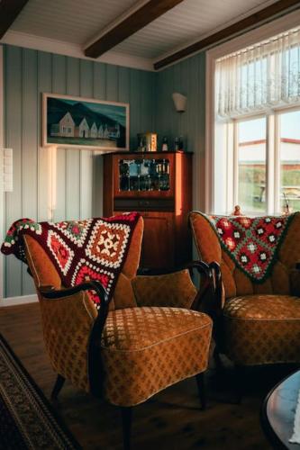 a living room with two chairs and a couch at Tanginn in Stykkishólmur