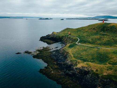 an island in the middle of a body of water at Tanginn in Stykkishólmur