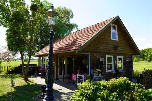 a house with a light pole in front of it at De Trouwerie in Emmen