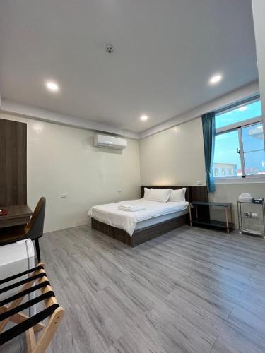 a bedroom with a bed and a large window at ChaoChaoINN in Chaozhou