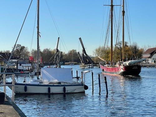 two boats are docked at a dock in the water at Haus Vicus in Greifswald