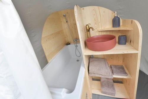 a small bathroom with a tub and a sink at Bulle Hirondelle in Quarré-les-Tombes