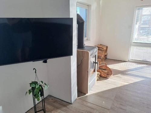a flat screen tv hanging on a wall in a living room at Chata Štíty in Štíty