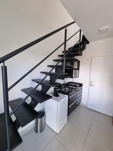 a staircase in a white room with a stove at 360 Perdizes in Sao Paulo