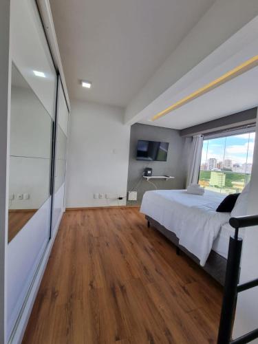 a bedroom with a bed and a large window at 360 Perdizes in Sao Paulo