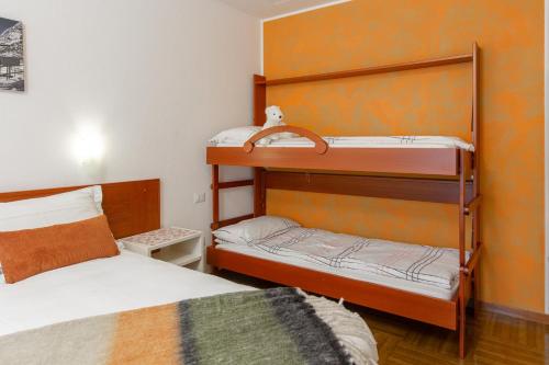 a bedroom with two bunk beds and a bed at Hotel Biancospino in Lanzada