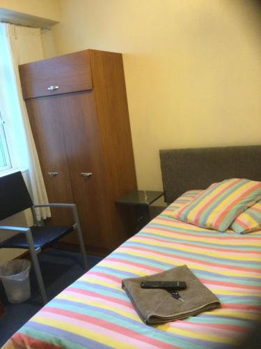 a bedroom with a bed with a remote control on it at Sea View Guest House in Hartlepool