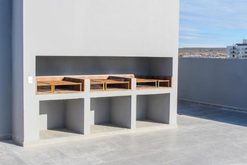 a white shelf on the side of a building at CQ MITRE in Puerto Madryn