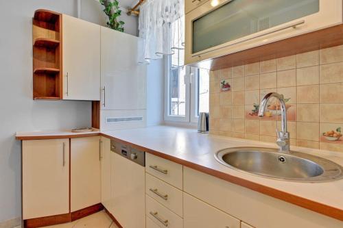 a kitchen with a sink and a window at Hello Apartments Sw Ducha Loft for 6 guests in Gdańsk