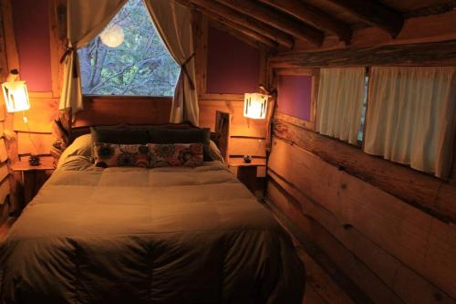 a bedroom with a bed in a room with a window at Mirador del Valle in Lago Puelo