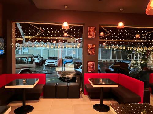 a car dealership with red booths and cars in a parking lot at Hotel Dunav in Vidin