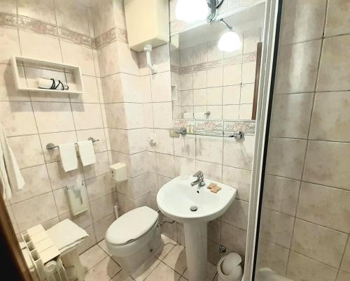 a small bathroom with a toilet and a sink at Hotel Castello Miramare in Genoa