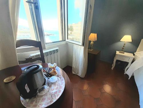 a hotel room with a table with a coffee maker on it at Hotel Castello Miramare in Genova