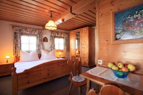 a bedroom with a bed and a table in a room at Appartement Seewaldhof in Brixen im Thale