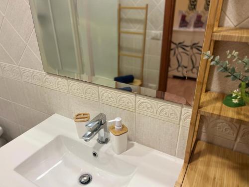 a bathroom with a white sink and a mirror at Juliette Rooms in Iesi