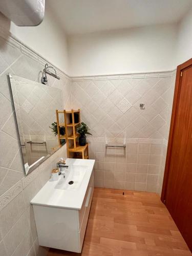 a bathroom with a white sink and a mirror at Juliette Rooms in Iesi