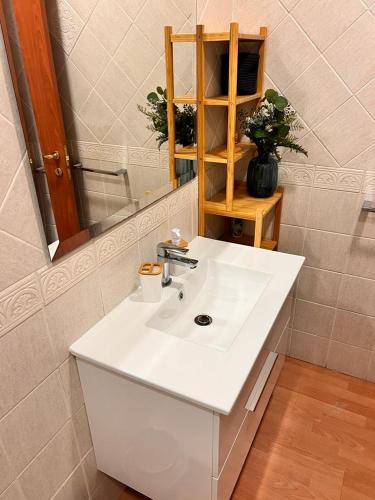 a bathroom with a white sink and a mirror at Juliette Rooms in Iesi