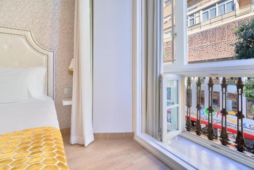 Ένα ή περισσότερα κρεβάτια σε δωμάτιο στο Tandem Soho Suites