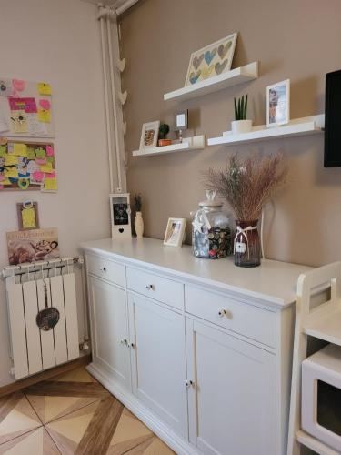 a white cabinet in a room with shelves at Relax Apartament in Constanţa