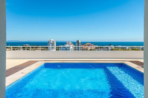 a swimming pool on the roof of a building at Amazing Sea View Apt with Pool Cascais - atjoanas in Cascais
