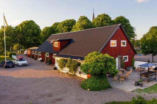 an aerial view of a red barn with a car parked outside at Halmstad Gårdshotell in Halmstad