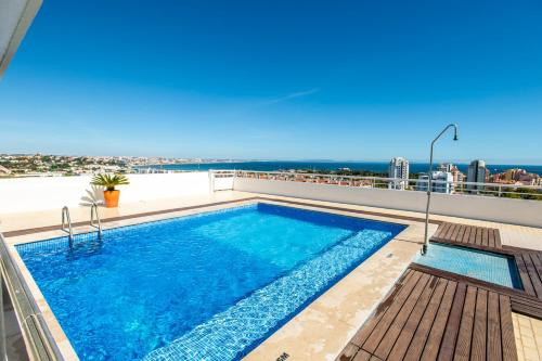 a swimming pool on the roof of a building at Amazing Sea View Apt with Pool Cascais - atjoanas in Cascais