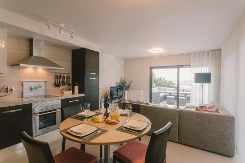 a kitchen and dining room with a table and chairs at Bica, luxury heated penthouses with jacuzzi and large terrace in Baleal in Baleal