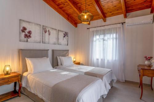 1 dormitorio con 2 camas y ventana en Alia Stone Villa-Ideal for families-Heated pool, en Nohia